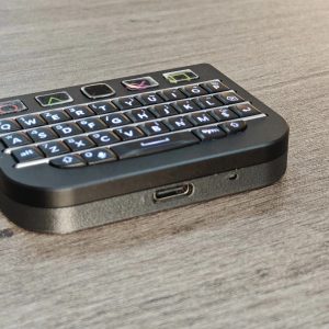 Black BBQ10KBD Pro mini keyboard showing its USB-C port and aluminum faceplate
