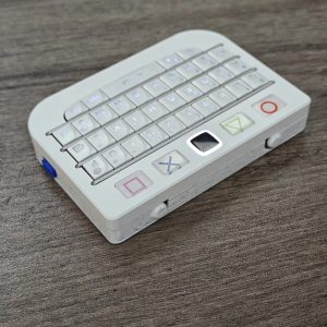 White BBQ10KBD Pro mini keyboard showing its side controls and compact body